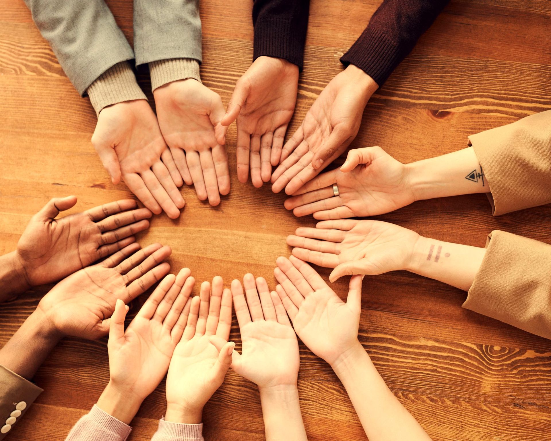 Hands forming a circle, group breathwork in Budapest